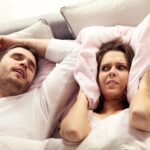 picture of angry woman with snoring partner in bed