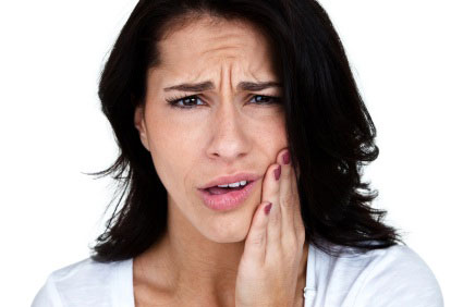 Woman experiencing tooth pain from a dental emergency in Allen Park, MI